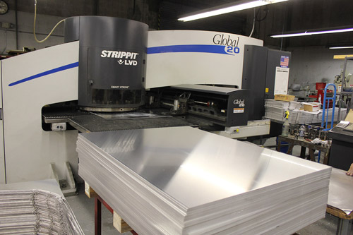 stanron team working with the lvt strippit machine